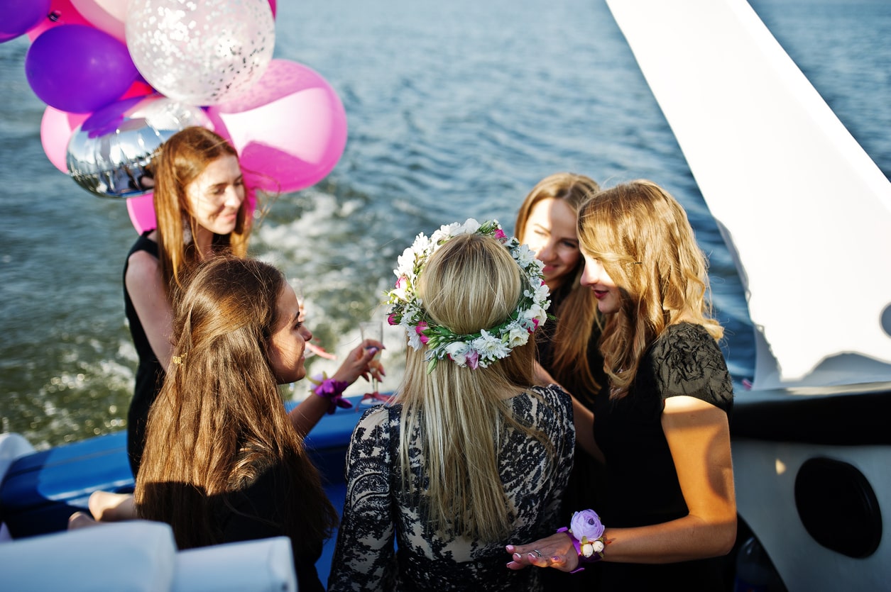 Bachelorette Party Celebration on a Luxury Yacht in Marbella, friends toasting with champagne at sunset